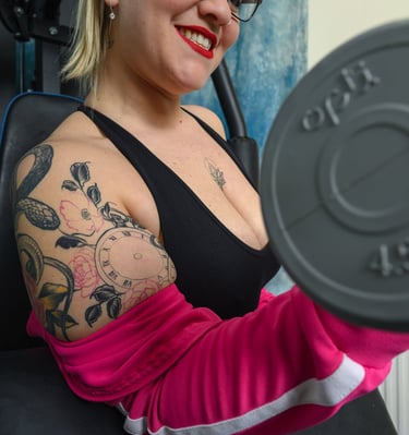 Model exercising with weights during creative studio photoshoot