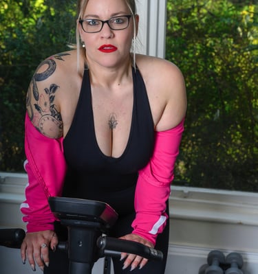 Model posing on an exercise bike during a studio photoshoot at Pretty in Pixels Rotherham