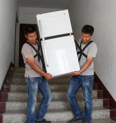Team carefully transporting a heavy refrigerator down a staircase.
