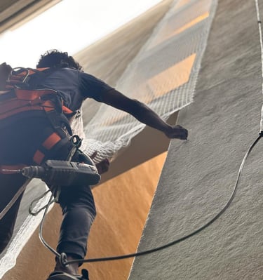 Sukumari Safety Nets team finishing up a pigeon net installation on a sunny day in Jayanagar.