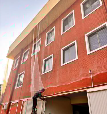 Close-up of sturdy safety nets securely fastened on a residential building in HSR Layout.