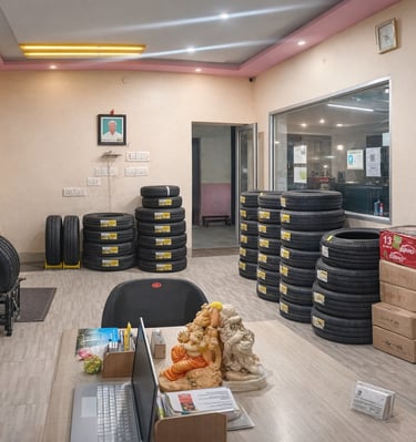 alt="Interior of Ranga Tyres shop with stacked car and bike tyres in a clean showroom"