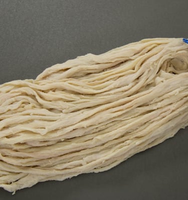 A bundle of natural Beef casings for sausage making, on a flat grey surface. at fivestarcasing.com