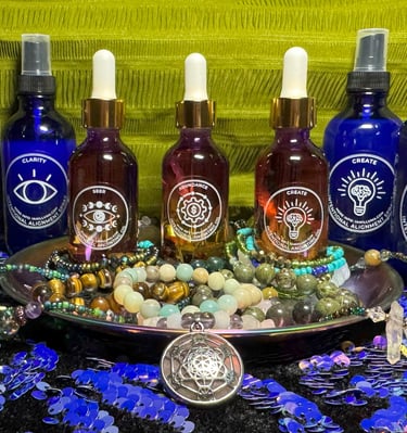 A decorative plate holding crystal jewelry with essential oil sprays & anointing oils in the middle