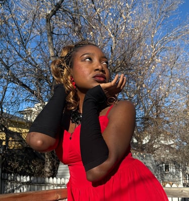 Iheoma Uzomba stylish pose in red gown and black gloves