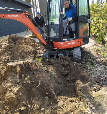 a man is standing in the dirt with a machine