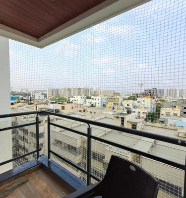Safety net installation in progress on a residential balcony in Adyar.