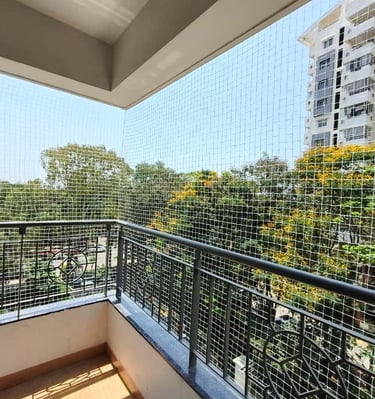 A freshly installed balcony safety net showing the fine mesh and sturdy frame.