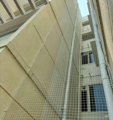 Wide shot showing a balcony protected with a safety net against birds and debris.