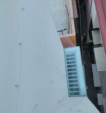 A clean, taut pigeon net stretched across a spacious balcony, blending seamlessly with the building’