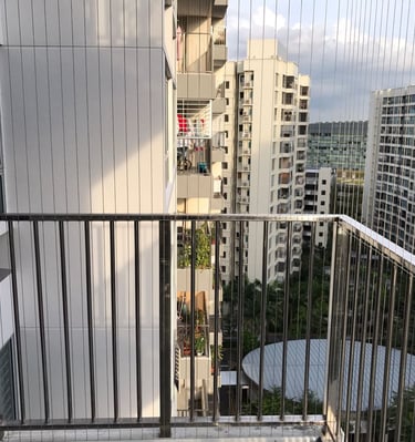 View of a child playing safely behind a newly installed balcony net.