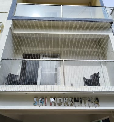 Close-up of a sleek invisible grill seamlessly blending with a balcony window in a Nungambakkam resi