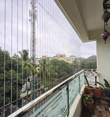 Invisible grills blending into the frame of a large living room window egmore chennai