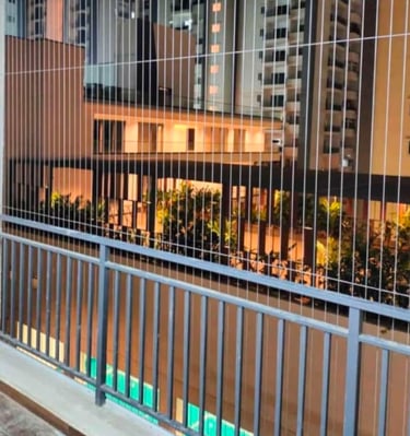 invisible grill installed on a Besant Nagar balcony with a sea view