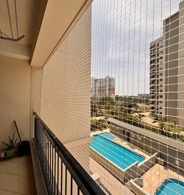 Side view of a balcony showing the neat installation of Arjilli safety pigeon nets.
