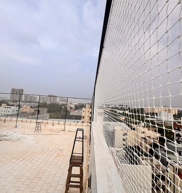 Close-up view of sturdy netting material tightly secured around a terrace sports area