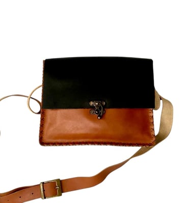 a small leather bag with a black and brown leather bag