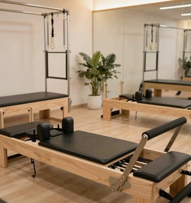 A group Pilates class in action, with participants engaged and smiling in a warm, inviting space.