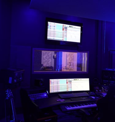 un studio d'enregistrement avec un clavier et un écran de moniteur