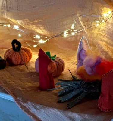 Escena de tardor amb figuretes de tela i llumetes, carbassa de llana i castanyes