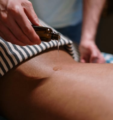 a person is getting a massage at a spa with oil