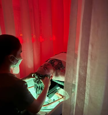 a woman in a mask massaging a head of a man