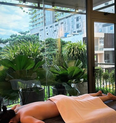 a woman is laying on a bed in a room with a view of a balcony