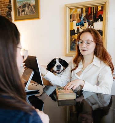 Kandelyne and her dog bonnie checking out a customer at Marigolds Bookstore