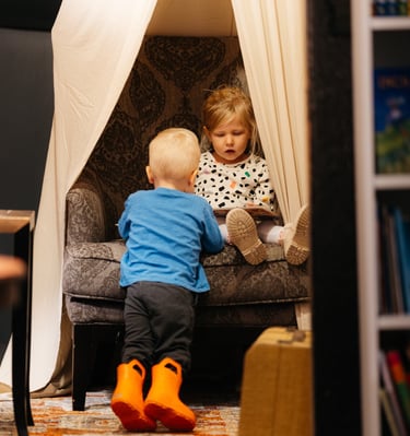Two children reading a book in the Harry potter room at Marigolds Bookstore