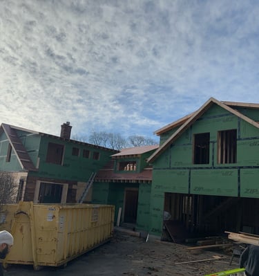 a man is working on a house being built