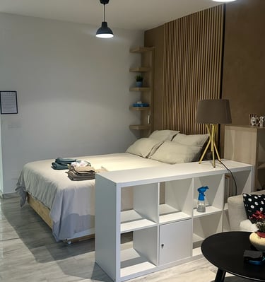 a bedroom with a bed and a couch
