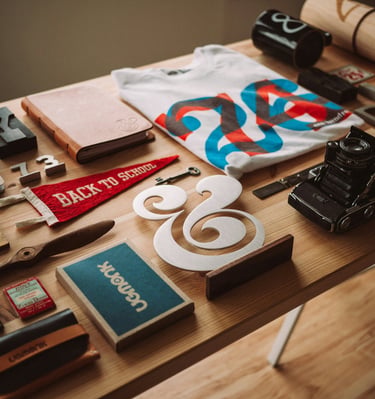 Flat lay of vintage stationery, a camera, and back to school supplies on a wooden desk.