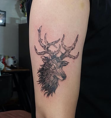 Ghostly elk tattoo on the upper arm with realistic style