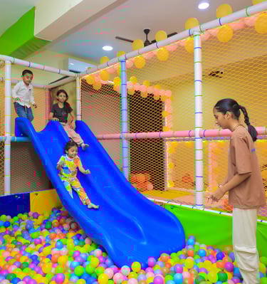 Kids sliding in the ball pool