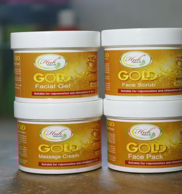 three jars of gold facial care products