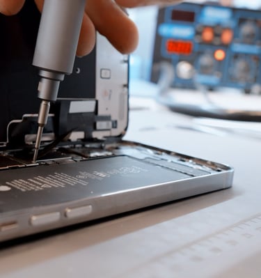 a person holding a small device with a small device