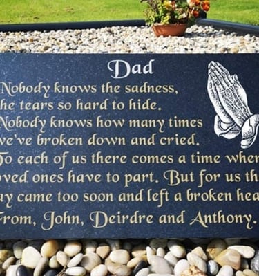 Memorial granite plaque for 'Dad' with engraved praying hands and a heartfelt message from family me