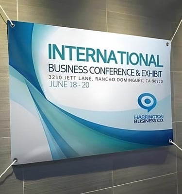 Printed banner for an international business conference with blue and green design elements.