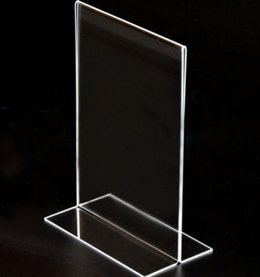 Clear T type acrylic display topper on a black background.