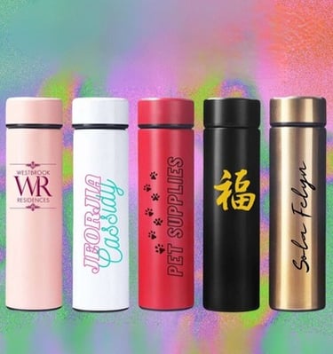 Set of five customized tumblers in various colors with different logos and text.