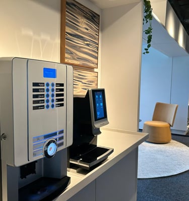 a coffee machine in a room with a chair and a chair