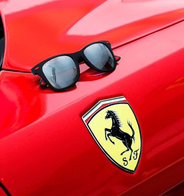 a pair of sunglasses and sunglasses on a red car