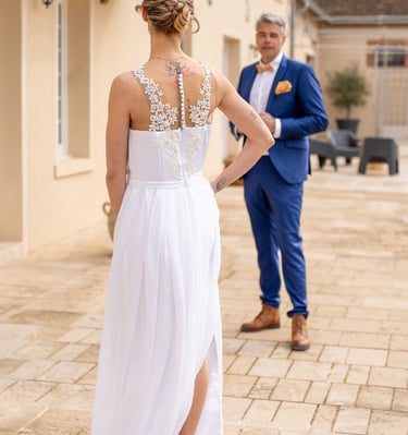 a bride and groom standing in front of a house