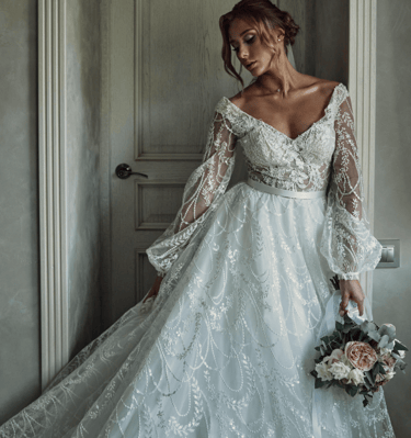 a woman in a wedding dress with a bouquet in her hand