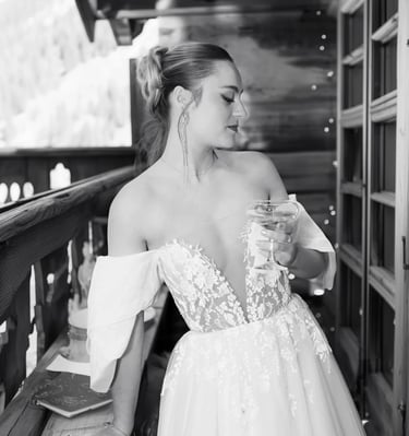 a woman in a wedding dress standing on a balcony