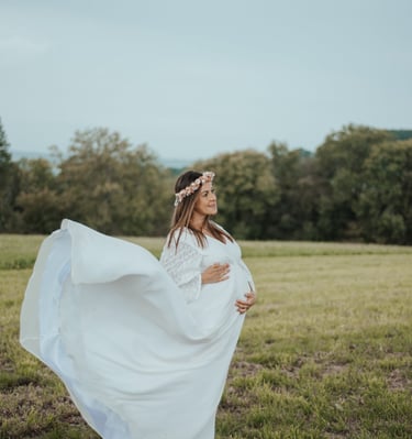 a pregnant woman in a white dress with a flower crown
