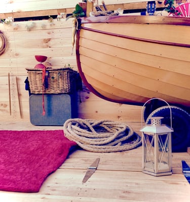 a wooden boat with lovely circus props