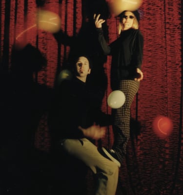 a man and woman beatnik doing an acrobatic balance