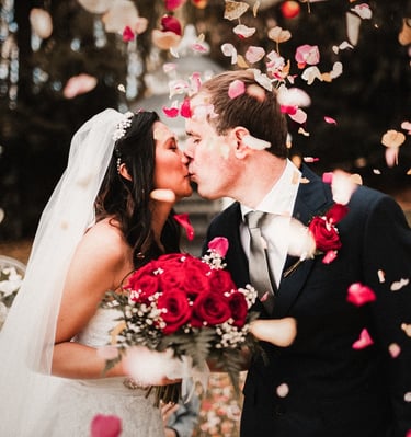 a bride and groom kissing in a wedding ceremony