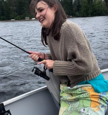 client fishing in lake with fishing guide